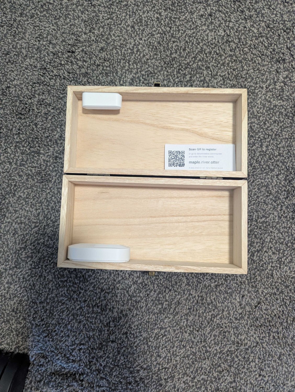 The DailyDoseBox open, showing the lid sensor and the setup QR label inside